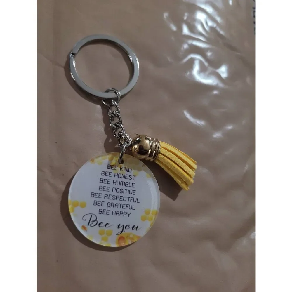 Be you. Positive yellow keychain with mini tassel